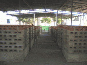 View of the composite boxes as a visitor enters the plant. The "holes' allow for oxygen to enter the compost.